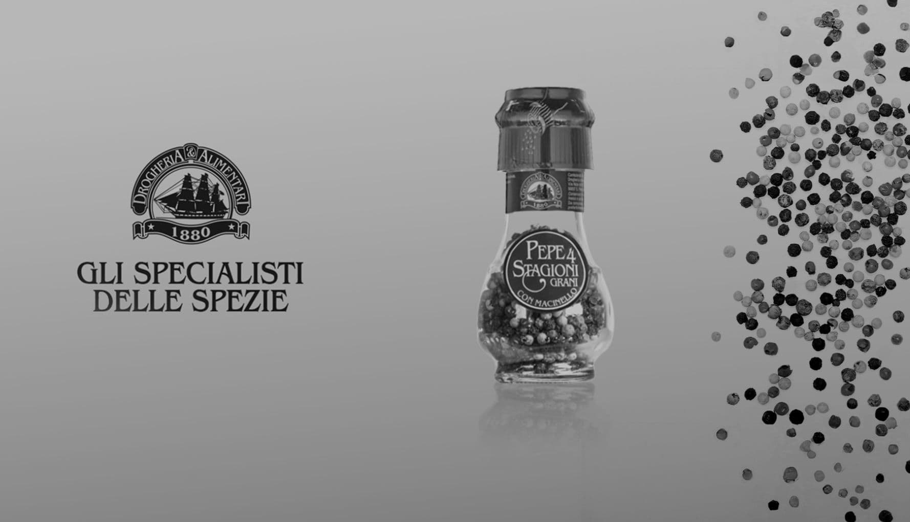 Macinino di pepe Drogheria & Alimentari con grani di pepe in volo, accanto al logo «Gli specialisti delle spezie»